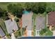 Aerial view of the home with a screened-in pool, lush landscaping, and well-kept lawns at 15776 Sw 11Th Terrace Rd, Ocala, FL 34473