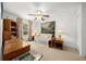 Neutral bedroom showcasing ceiling fan, carpet and large windows with coverings at 15776 Sw 11Th Terrace Rd, Ocala, FL 34473