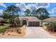 Charming home featuring a brick driveway, well-maintained landscaping, and an American flag at 15776 Sw 11Th Terrace Rd, Ocala, FL 34473