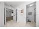 Hallway leading to rooms including a bathroom and bedroom featuring neutral tile at 15776 Sw 11Th Terrace Rd, Ocala, FL 34473