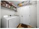 A utility room featuring a white washer and dryer, wire shelving, and white walls at 15776 Sw 11Th Terrace Rd, Ocala, FL 34473