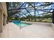 Enclosed screened pool area features a long, narrow pool with a view of the backyard at 15776 Sw 11Th Terrace Rd, Ocala, FL 34473