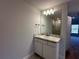 Bathroom vanity with granite countertop, sink, and a decorative mirror at 180 Willow Rd, Ocala, FL 34472