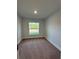 Cozy bedroom featuring carpeted floors and a bright window with views of greenery at 180 Willow Rd, Ocala, FL 34472