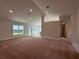 Spacious living room featuring plush carpeting and large windows at 180 Willow Rd, Ocala, FL 34472