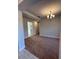 Spacious living room featuring carpeted floors and a decorative light fixture at 180 Willow Rd, Ocala, FL 34472