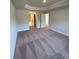 Large bedroom with neutral walls, carpet, tray ceiling, and a view into the ensuite at 180 Willow Rd, Ocala, FL 34472