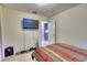 Modest bedroom with tile floors, minimal furniture, and access to another room at 2508 India Palm Dr, Edgewater, FL 32141