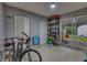 Functional garage space with tile floors, storage shelves, and bikes at 2508 India Palm Dr, Edgewater, FL 32141