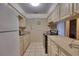 Functional kitchen with light cabinets, tile floor, laminate counters and black appliances at 2508 India Palm Dr, Edgewater, FL 32141