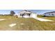 Cozy one-story home with gray siding, a garage, and a simple front porch on a grassy lot at 2728 Sw 147Th Ter, Ocala, FL 34481