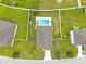 Aerial view of home showcasing a backyard with well-kept lawn and a sparkling swimming pool at 2984 Ne 43Rd Rd, Ocala, FL 34470