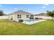 The sprawling backyard features a sparkling pool and outdoor seating, perfect for entertaining guests at 2984 Ne 43Rd Rd, Ocala, FL 34470
