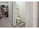 Bathroom featuring walk-in closet, toilet, and decorative rug on gray tile floor at 2984 Ne 43Rd Rd, Ocala, FL 34470