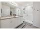 Bright bathroom features a double sink vanity, a glass-enclosed shower, and modern fixtures and finishes at 2984 Ne 43Rd Rd, Ocala, FL 34470