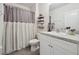 Cozy bathroom featuring a shower with a curtain, a toilet, and a vanity at 2984 Ne 43Rd Rd, Ocala, FL 34470