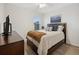 A serene bedroom with neutral decor and a dark wooden bed frame at 2984 Ne 43Rd Rd, Ocala, FL 34470