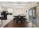Dining area with a dark wood table, black bar stools, and sliding glass doors to the patio at 2984 Ne 43Rd Rd, Ocala, FL 34470