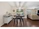 Dining area featuring dark wood floors, a table with stools, and sliding glass doors at 2984 Ne 43Rd Rd, Ocala, FL 34470