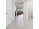 Bright hallway with tile flooring leading to a living area with neutral furniture at 2984 Ne 43Rd Rd, Ocala, FL 34470