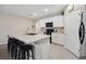 Open kitchen with a large center island, black bar stools, and tile flooring at 2984 Ne 43Rd Rd, Ocala, FL 34470