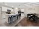 Open-concept kitchen featuring a large island, black bar stools, and tile floors at 2984 Ne 43Rd Rd, Ocala, FL 34470