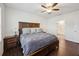 Stylish main bedroom with hardwood floors, a spacious king-size bed, and an adjacent bathroom with a walk-in shower at 2984 Ne 43Rd Rd, Ocala, FL 34470