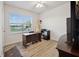 Bright office space with wood floors, a ceiling fan, and a large window with blinds at 2984 Ne 43Rd Rd, Ocala, FL 34470