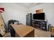 A functional office space with wood floors, large TV and desk at 2984 Ne 43Rd Rd, Ocala, FL 34470