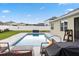 Inviting pool area with patio furniture, lush landscaping, and a relaxing ambiance at 2984 Ne 43Rd Rd, Ocala, FL 34470