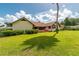 Lush backyard featuring a well-maintained lawn and a charming deck, perfect for outdoor relaxation and activities at 3555 Sw 24Th Avenue Rd, Ocala, FL 34471