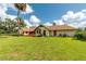 Large backyard features a lush green lawn, mature trees, providing a serene and private outdoor space at 3555 Sw 24Th Avenue Rd, Ocala, FL 34471