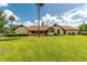 Spacious backyard with a manicured lawn, providing ample space for outdoor enjoyment and activities at 3555 Sw 24Th Avenue Rd, Ocala, FL 34471