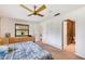 Comfortable bedroom with an ensuite bathroom, ceiling fan, and neutral carpet throughout at 3555 Sw 24Th Avenue Rd, Ocala, FL 34471