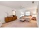 Cozy bedroom with soft lighting, a ceiling fan, and a mirror and dresser at 3555 Sw 24Th Avenue Rd, Ocala, FL 34471