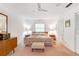 Well-lit bedroom features soft lighting, a ceiling fan, and neutral-colored carpet at 3555 Sw 24Th Avenue Rd, Ocala, FL 34471