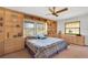 Bright bedroom features built-in shelving, a ceiling fan, and scenic views from the windows at 3555 Sw 24Th Avenue Rd, Ocala, FL 34471