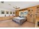 Spacious bedroom boasts built in cabinetry, drawers, and shelves with neutral carpet and a ceiling fan at 3555 Sw 24Th Avenue Rd, Ocala, FL 34471