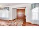 Inviting foyer features double doors, wood floors, and natural light streaming through sheer-curtained windows at 3555 Sw 24Th Avenue Rd, Ocala, FL 34471