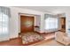 Inviting foyer features double doors, wood floors, and natural light streaming through sheer-curtained windows at 3555 Sw 24Th Avenue Rd, Ocala, FL 34471