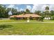 Beautiful brick home featuring lush lawn, mature trees, and a walkway to a bright double door entry at 3555 Sw 24Th Avenue Rd, Ocala, FL 34471