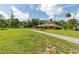 Brick home on sprawling green lot featuring mature trees and a long driveway at 3555 Sw 24Th Avenue Rd, Ocala, FL 34471