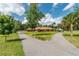 Brick home on sprawling green lot featuring mature trees, circular driveway and large shade tree at 3555 Sw 24Th Avenue Rd, Ocala, FL 34471