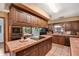 Kitchen featuring tile countertops and flooring, wood cabinetry, and included appliances at 3555 Sw 24Th Avenue Rd, Ocala, FL 34471