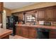Kitchen features tiled countertops, updated wood cabinetry, and black appliances at 3555 Sw 24Th Avenue Rd, Ocala, FL 34471