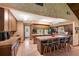 Eat-in kitchen with tile countertops and flooring, wood cabinetry, and breakfast bar seating at 3555 Sw 24Th Avenue Rd, Ocala, FL 34471