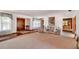 Spacious living room boasts plush carpet, large windows, and a seamless flow for entertaining at 3555 Sw 24Th Avenue Rd, Ocala, FL 34471