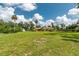 Expansive lot showcases a lush lawn, mature trees, and beautiful landscaping, creating a serene setting at 3555 Sw 24Th Avenue Rd, Ocala, FL 34471