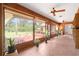 Bright sunroom featuring floor-to-ceiling windows showcasing views of the landscaped backyard and patio at 3555 Sw 24Th Avenue Rd, Ocala, FL 34471