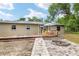 Charming backyard with a brick-paved patio, firepit, and wooden deck, ideal for relaxation and outdoor gatherings at 3640 Se 131St Ln, Belleview, FL 34420